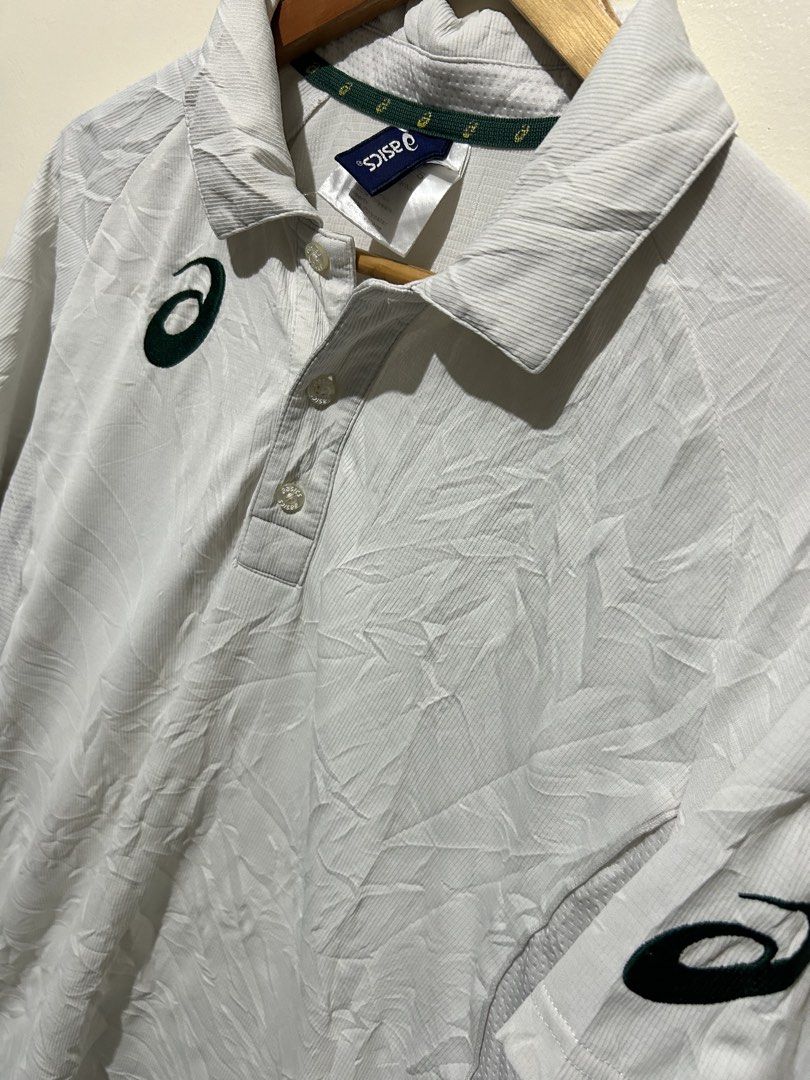 Asics White Polo Shirt (Category: Tshirts & Polo Shirts ) located in Angeles City. Submitted by johngamboa (Listing ID 1466961459, Image 2). Description: - Color: Crisp white with stylish green branding on the chest and left sleeve - Material: Premium blend of 90% polyester and 10% elastane for a comfortable, flexible fit - Design: Classic three-button placket, standard collar with Asics logo tape on the inner neckline - Details: Short sleeves wi
