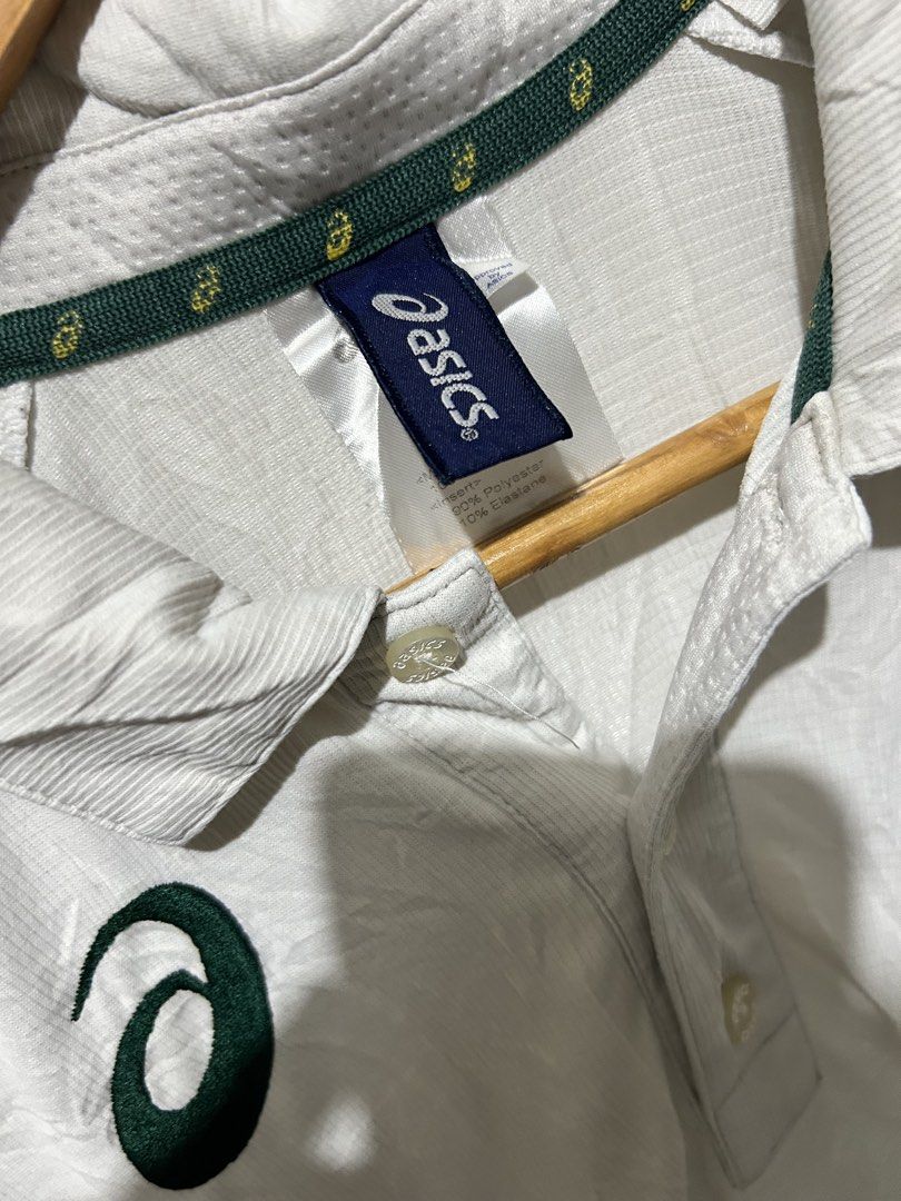 Asics White Polo Shirt (Category: Tshirts & Polo Shirts ) located in Angeles City. Submitted by johngamboa (Listing ID 1466961459, Image 3). Description: - Color: Crisp white with stylish green branding on the chest and left sleeve - Material: Premium blend of 90% polyester and 10% elastane for a comfortable, flexible fit - Design: Classic three-button placket, standard collar with Asics logo tape on the inner neckline - Details: Short sleeves wi