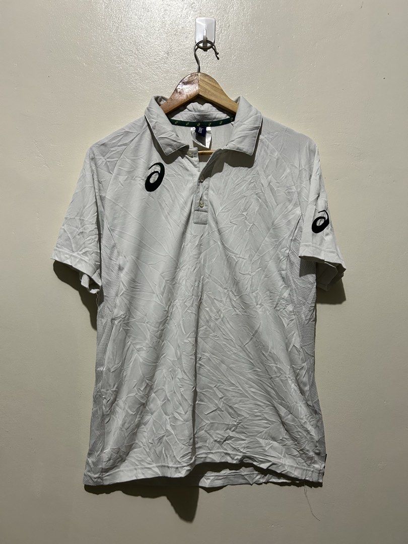 Asics White Polo Shirt (Category: Tshirts & Polo Shirts ) located in Angeles City. Submitted by johngamboa (Listing ID 1466961459, Image 1). Description: - Color: Crisp white with stylish green branding on the chest and left sleeve - Material: Premium blend of 90% polyester and 10% elastane for a comfortable, flexible fit - Design: Classic three-button placket, standard collar with Asics logo tape on the inner neckline - Details: Short sleeves wi