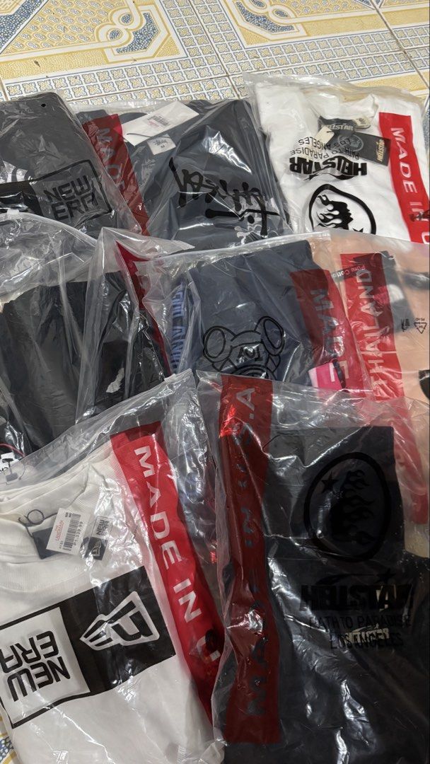 Assorted Branded T-Shirts New in Packaging (Category: Tshirts & Polo Shirts ) located in Davao. Submitted by andenggg.itt (Listing ID 1466809081, Image 1). Description: - Condition: Brand new, still sealed in plastic bags with tags attached - Brands included: New Era, Hellstar, The North Face, and Stussy - Variety: Mixed colors and styles packed together - Perfect for: Resellers looking for stock or anyone wanting a quick wardrobe refresh - Avail