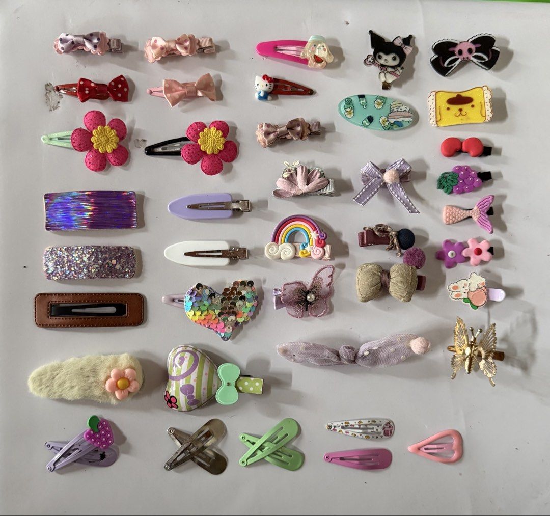 Assorted cute hair clips and pins collection (Category: Hair Accessories) located in Binan City. Submitted by prelovedlagunaph (Listing ID 1466968408, Image 1). Description: - Lot of ~30 assorted hair clips, bows, and snap pins - Features Sanrio characters, flowers, rainbows, sequins, and pearls - Mix of pastel and vibrant colors in various shapes and sizes - Great for daily wear, school, or styling - Selling as a complete set only.