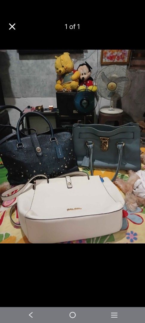 Assorted Designer Handbags Coach Michael Kors Bundle (Category: Luxury Bags & Wallets) located in Malabon City. Submitted by mariteserp44633 (Listing ID 1466809298, Image 1). Description: - Choice of 3 stylish bags available for individual purchase or as a bundle - Item 1: Dark blue studded Coach bag with top handles and matching leather hangtag - Item 2: Light blue structured bag accented with chic metal lock hardware - Item 3: Cream white struc