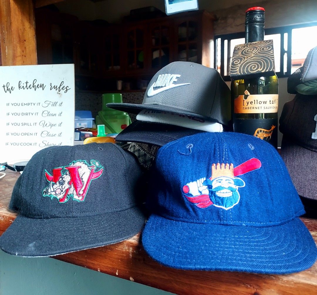 Assorted Vintage Caps and Snapbacks (Category: Caps & Hats) located in Tagbilaran City. Submitted by topernzvault (Listing ID 1466847306, Image 1). Description: - Grey Nike snapback - Blue hat with king mascot graphic - Black hat with W logo and boar embroidery - Mix of styles stored on wooden shelf - Available individually or as a bundle..all made in USA.