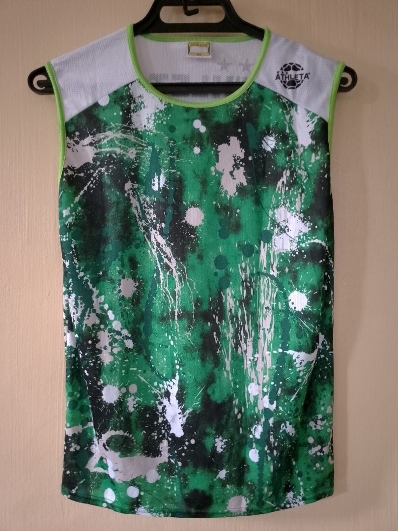 Athleta Green Splatter Print Sleeveless Athletic Top (Category: Sleeveless) located in Bayombong. Submitted by daily10 (Listing ID 1466880391, Image 2). Description: - Brand: Athleta - Est Size: 160 (M) - Dimensions: 18" x 25" - Style: Sleeveless athletic shirt / activewear tank - Design: Green, black, and white splatter paint pattern on the front - Details: White mesh upper shoulders with lime green piping trim and round neckline - Fabric: Light