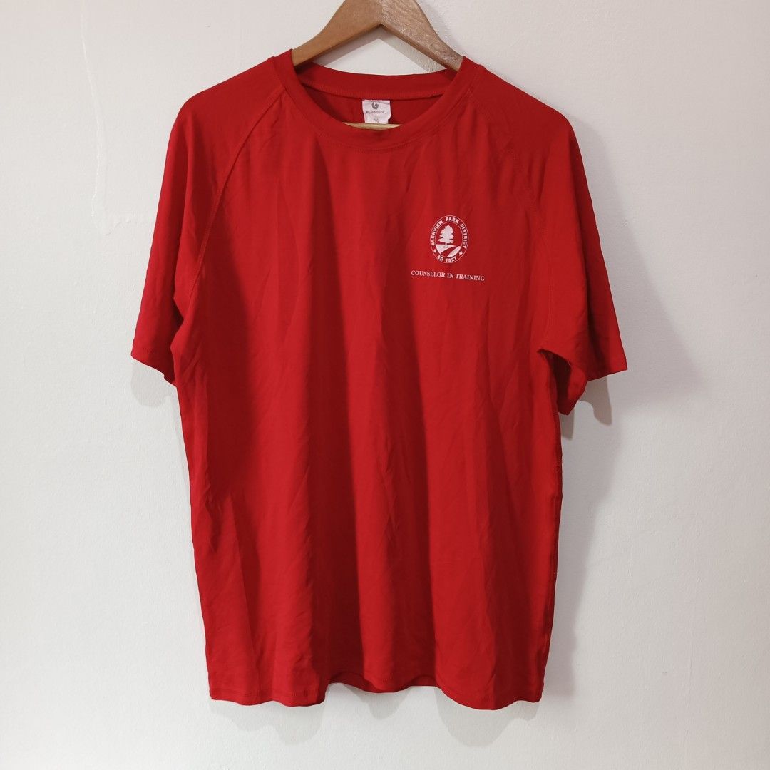 Athletic Shirt (Red) | M (Category: Activewear) located in Subic. Submitted by mustardt_ (Listing ID 1466836532, Image 1). Description: A solid red crew-neck activewear with raglan sleeves by Burnside. Features the Glenview Park District logo and "COUNSELOR IN TRAINING" printed in white on the left chest. size: 22in x 28in code: c800.