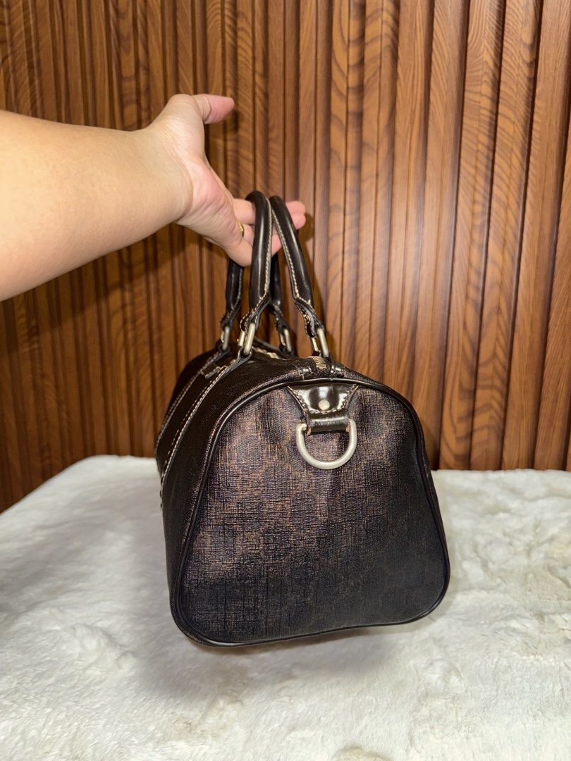 Authentic Gucci Monogram Boston Bag with Strap (Category: Luxury Bags & Wallets) located in Subic. Submitted by luxshoppe88 (Listing ID 1466877644, Image 3). Description: - Authentic Gucci dark brown monogram Boston bag - Durable textured canvas finish with structured patent leather trim and handles - Secure zip top closure with spacious everyday interior - Includes matching adjustable leather shoulder strap with gold-tone hardware - Convenient s