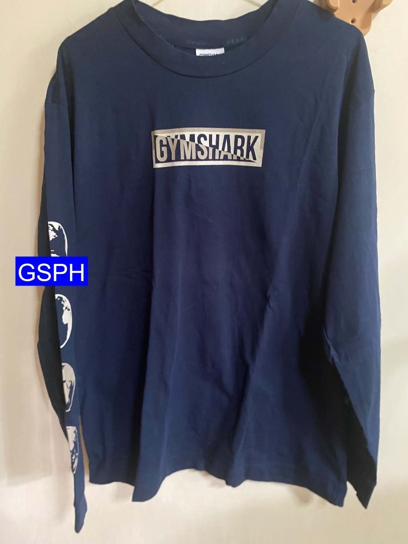 Authentic Gymshark Navy Long Sleeve (Category: Activewear) located in Makati City. Submitted by goodiesstuff_ph_17119811 (Listing ID 1466860736, Image 1). Description: Bought this on Gymshark application ROW, shipped from Belgium. The size is XS but it was an adult US-EU standard size. For Filipino like me the size is too big, worn this only three times. - Brand: Gymshark - Color: Navy blue - Design: Graphic box logo on chest, large lettering on 