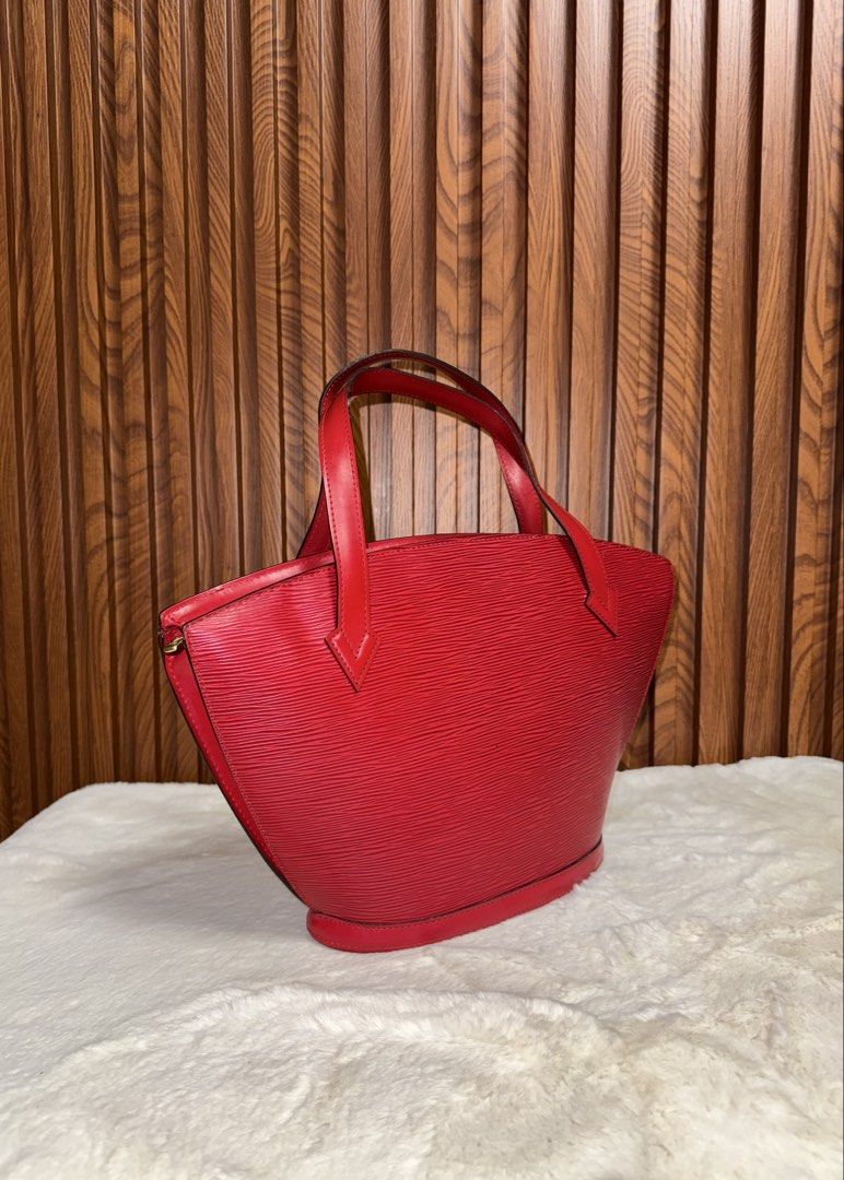 Authentic Louis Vuitton Epi Leather Red Handbag (Category: Luxury Bags & Wallets) located in Subic. Submitted by luxshoppe88 (Listing ID 1466875910, Image 2). Description: - Brand: Louis Vuitton - Material: Textured Epi leather in a striking bright red shade - Style: Classic structured bucket shape with dual top handles - Closure: Secure top zip closure - Details: Subtle embossed LV logo near the base, clean red leather bottom and side panels - C