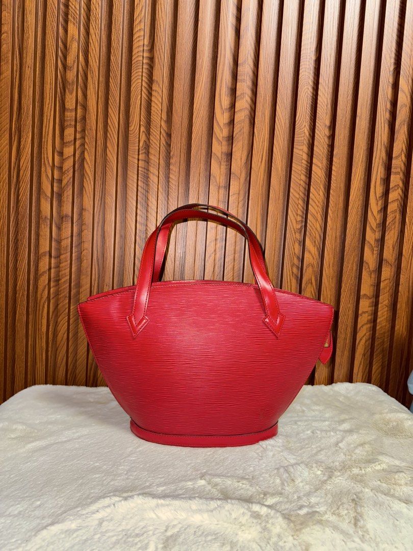 Authentic Louis Vuitton Epi Leather Red Handbag (Category: Luxury Bags & Wallets) located in Subic. Submitted by luxshoppe88 (Listing ID 1466875910, Image 1). Description: - Brand: Louis Vuitton - Material: Textured Epi leather in a striking bright red shade - Style: Classic structured bucket shape with dual top handles - Closure: Secure top zip closure - Details: Subtle embossed LV logo near the base, clean red leather bottom and side panels - C