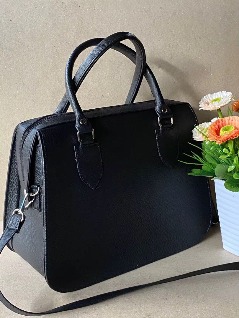 Authentic Marikina Bag (Category: Tote Bags) located in Cavite. Submitted by t_m_jazmin (Listing ID 1466916543, Image 1). Description: - Color/Material: Black textured leather - Hardware: Silver-tone details - Straps: Dual top handles and a detachable long shoulder strap - Design: Structured rectangular shape with rounded bottom corners - Interior: Clean lining with secure zip closure - Capacity: Spacious enough to fit your daily essentials easil