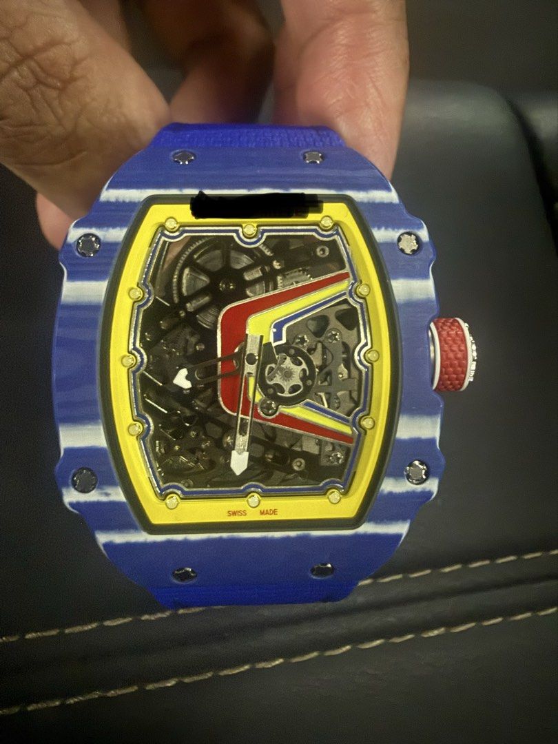Automatic Watch (Category: Watches) located in Singapore. Submitted by rareearth-e1ac (Listing ID 1466776147, Image 1). Description: Automatic Thin Watch 39mm - Case: Lightweight Blue NTPT Carbon with exhibition case back. - Dial: Skeleton dial featuring a yellow inner flange, red and yellow graphic accents. - Movement: automatic movement with moving gear at 7oclock. - Strap: Textured blue strap with a subtle red crown detail. - Deal method: Meet
