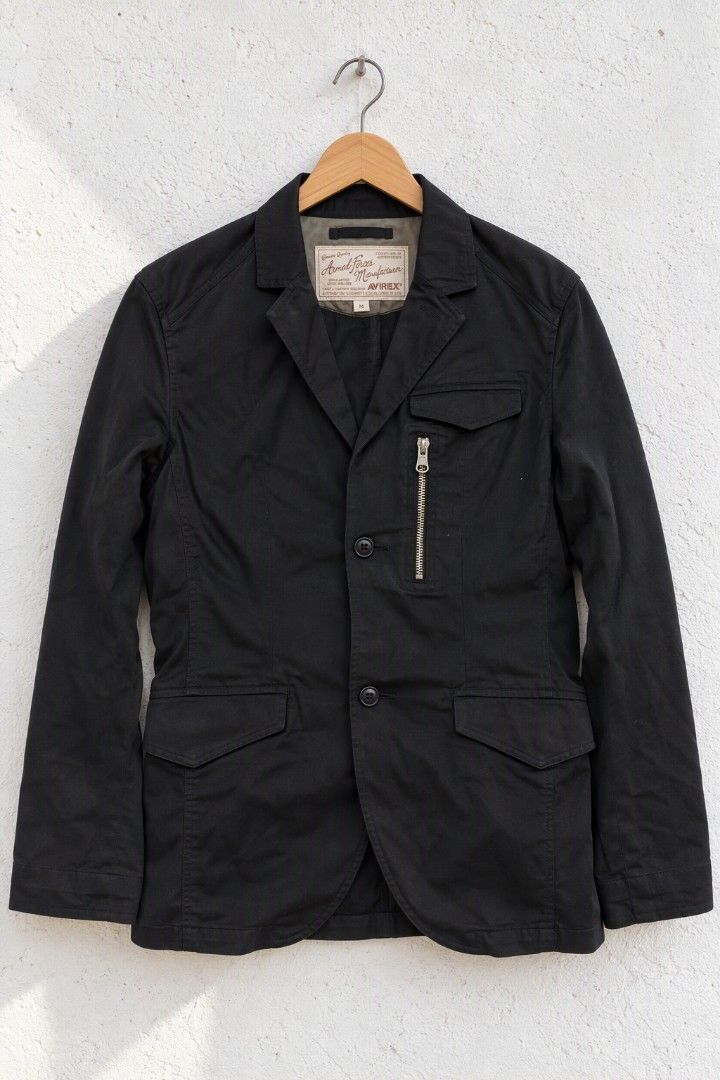 AVIREX Military Utility Blazer (Category: Coats, Jackets and Outerwear) located in Baguio. Submitted by luxeloomarchive (Listing ID 1466776460, Image 1). Description: Upgrade your casual style with this authentic AVIREX Military Utility Blazer. Crafted from durable black cotton canvas, this versatile piece features a rugged yet tailored design with a unique vertical zippered chest pocket and classic flap pockets. The interior collar is finished w