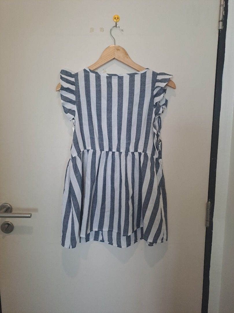Babay doll sleeveless (Category: Sleeveless) located in Manila. Submitted by joanbalde39643 (Listing ID 1466837827, Image 3). Description: The item featured is a blue and white vertically striped babydoll top from the brand SHEIN. It features a flattering V-neckline, short ruffed/flounce sleeves, and an empire waist that flows out into a relaxed bodice..