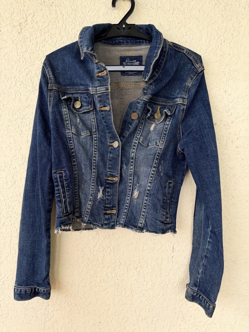 Babu The Cowboy Expert Distressed Denim Jacket (Category: Coats, Jackets and Outerwear) located in Tubigon. Submitted by gypsea.soulph (Listing ID 1466949094, Image 1). Description: - Brand: Babu The Cowboy Expert - Color: Dark blue with faded wash details - Design: Pre-distressed look with a raw, frayed hem and contrast stitching - Pockets: Dual chest pockets and side welt pockets - Closure: Classic front button closure - Style: Structured denim