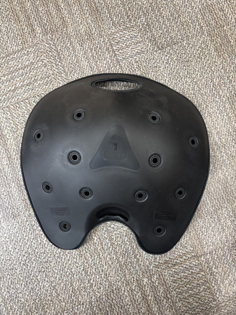 BackJoy SitSmart Core Posture Seat Black (Category: Braces, Support & Protection) located in Taguig. Submitted by grekoriog (Listing ID 1466792248, Image 3). Description: - Brand: BackJoy SitSmart Core 1.0 - Color: Classic Black - Condition: Good, clean with minimal wear - Design: Ergonomic contoured shape with ventilation holes and grab handle - Benefits: Instantly relieves back pain and corrects posture for pelvis and lower back - Versatility: 