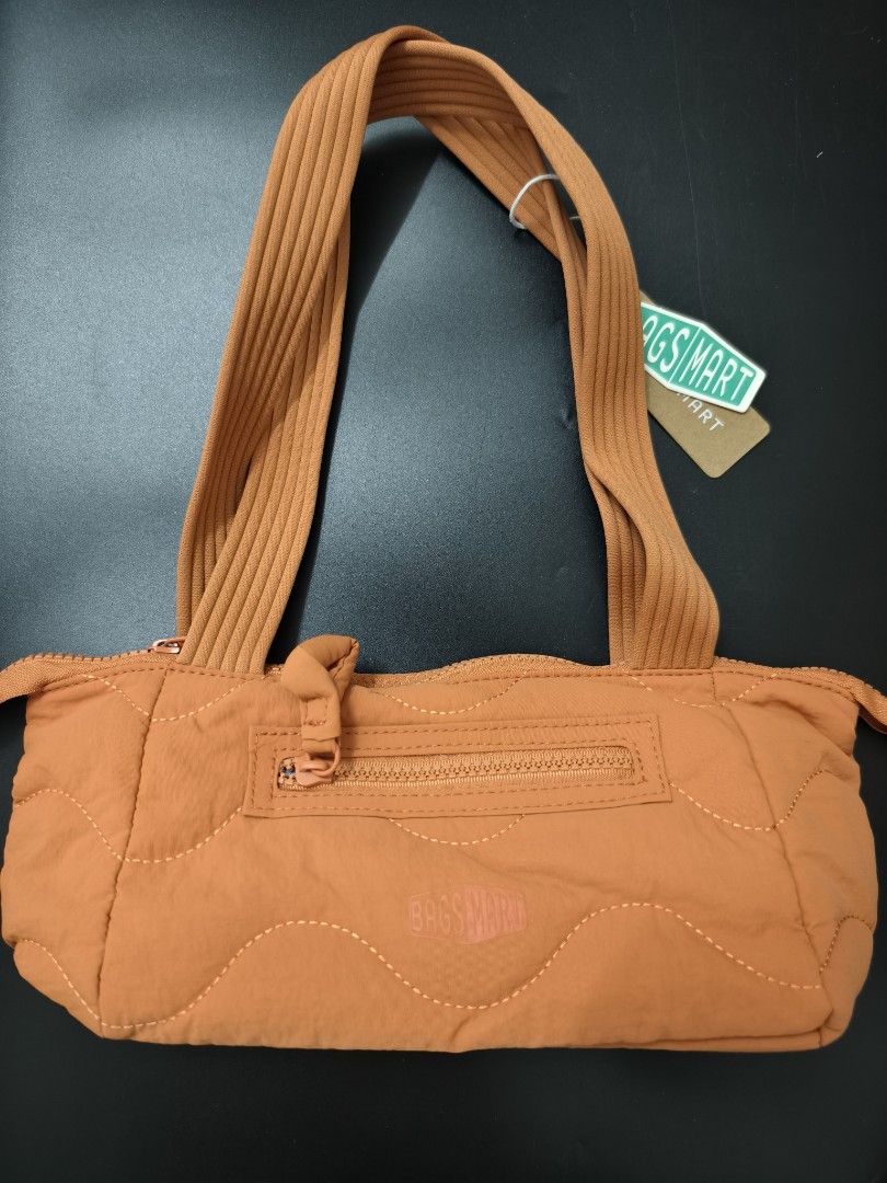 BAGSMART Quilted Orange Shoulder Bag (Category: Shoulder Bags) located in Angeles City. Submitted by measaliman02351 (Listing ID 1466882967, Image 3). Description: - Brand: BAGSMART - Color: Vibrant orange - Material: Soft puffed nylon with trendy wave stitch pattern - Handles: Dual ribbed top handles for comfortable carrying - Pockets: Convenient front zip pocket with pull tab and embossed logo patch - Closure: Secure main zip closure across the