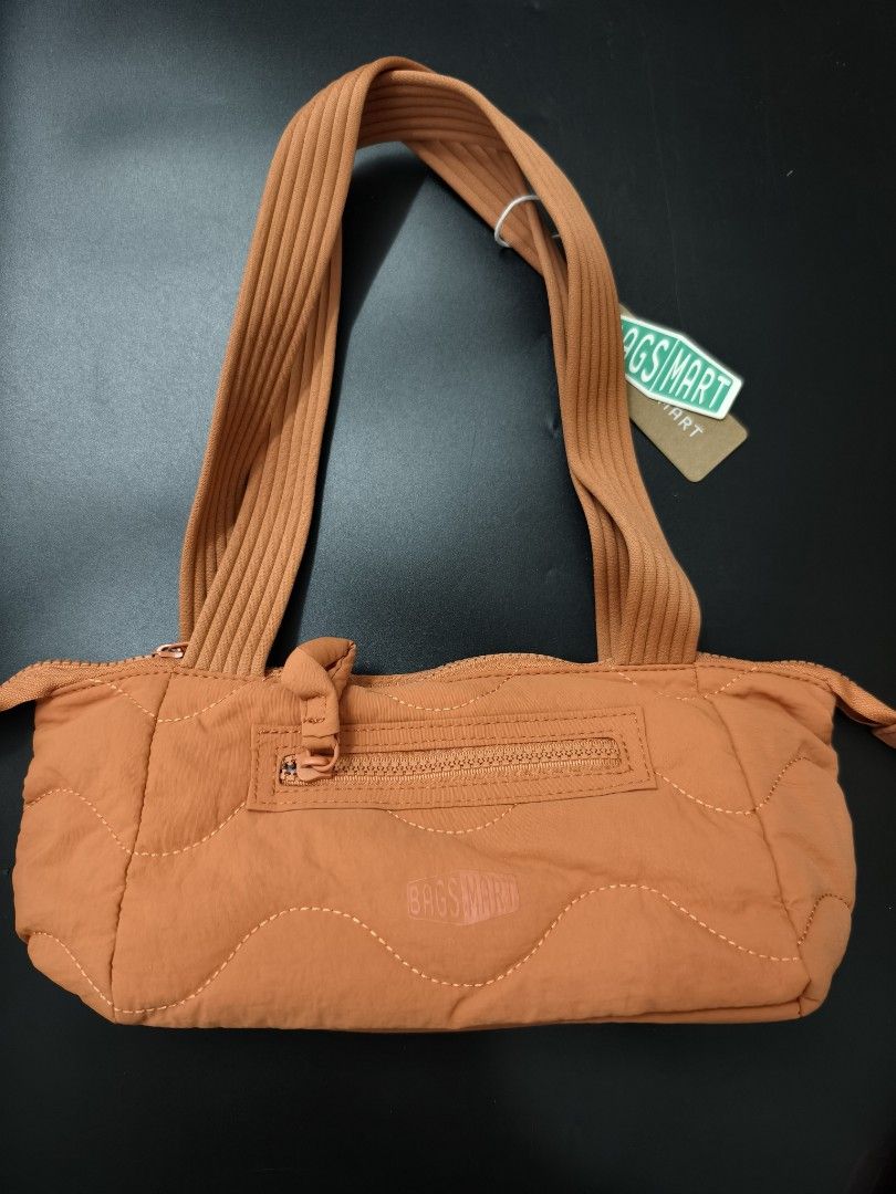 BAGSMART Quilted Orange Shoulder Bag (Category: Shoulder Bags) located in Angeles City. Submitted by measaliman02351 (Listing ID 1466882967, Image 1). Description: - Brand: BAGSMART - Color: Vibrant orange - Material: Soft puffed nylon with trendy wave stitch pattern - Handles: Dual ribbed top handles for comfortable carrying - Pockets: Convenient front zip pocket with pull tab and embossed logo patch - Closure: Secure main zip closure across the