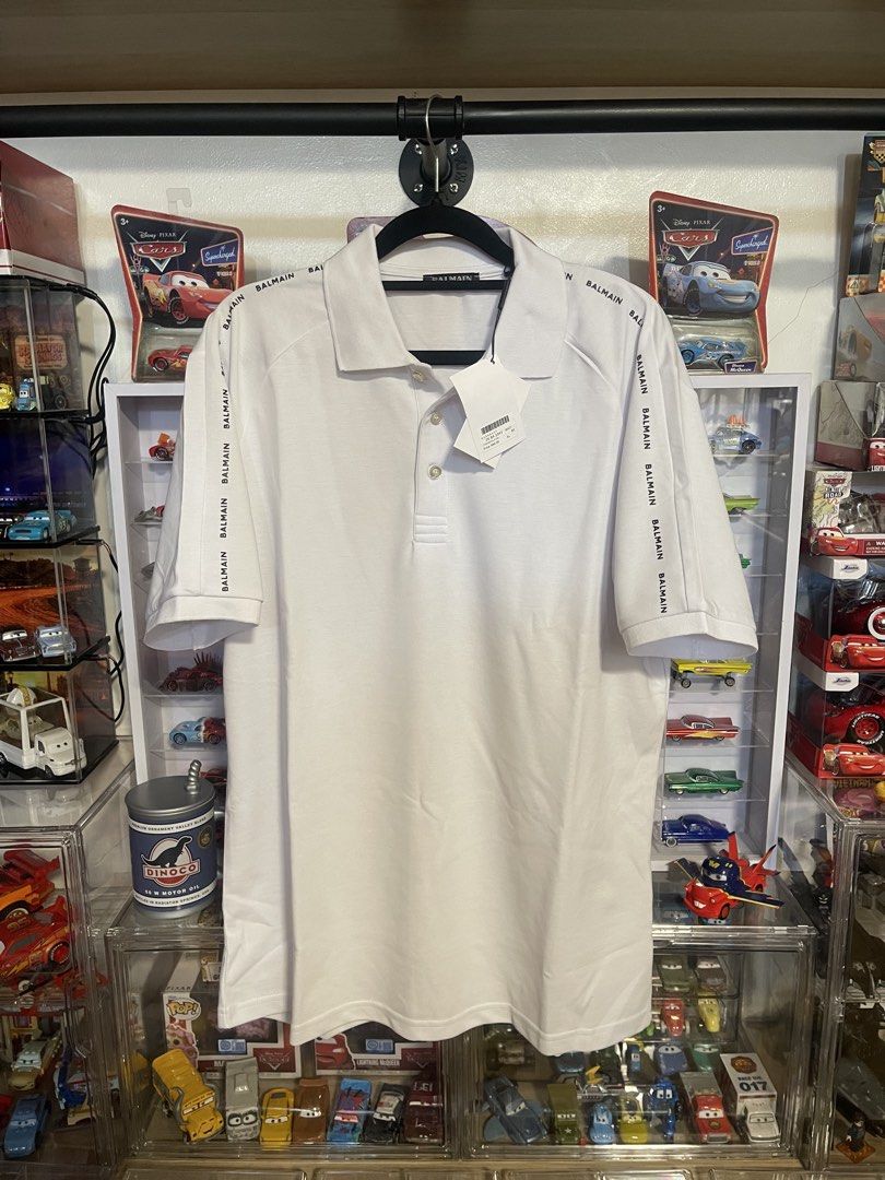 Balmain White Logo Polo Shirt (Category: Tshirts & Polo Shirts ) located in Manila. Submitted by thenotoriusthrift (Listing ID 1466778569, Image 1). Description: Brand: Balmain Color: Crisp White with Contrast Black Logo Tape Condition: Brand New with Original Hang Tags (Not a thrifted item) Size: 23 by 29 (XL) .
