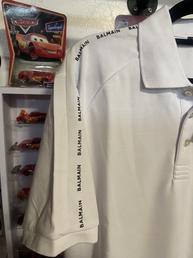 Balmain White Logo Polo Shirt (Category: Tshirts & Polo Shirts ) located in Manila. Submitted by thenotoriusthrift (Listing ID 1466778569, Image 3). Description: Brand: Balmain Color: Crisp White with Contrast Black Logo Tape Condition: Brand New with Original Hang Tags (Not a thrifted item) Size: 23 by 29 (XL) .