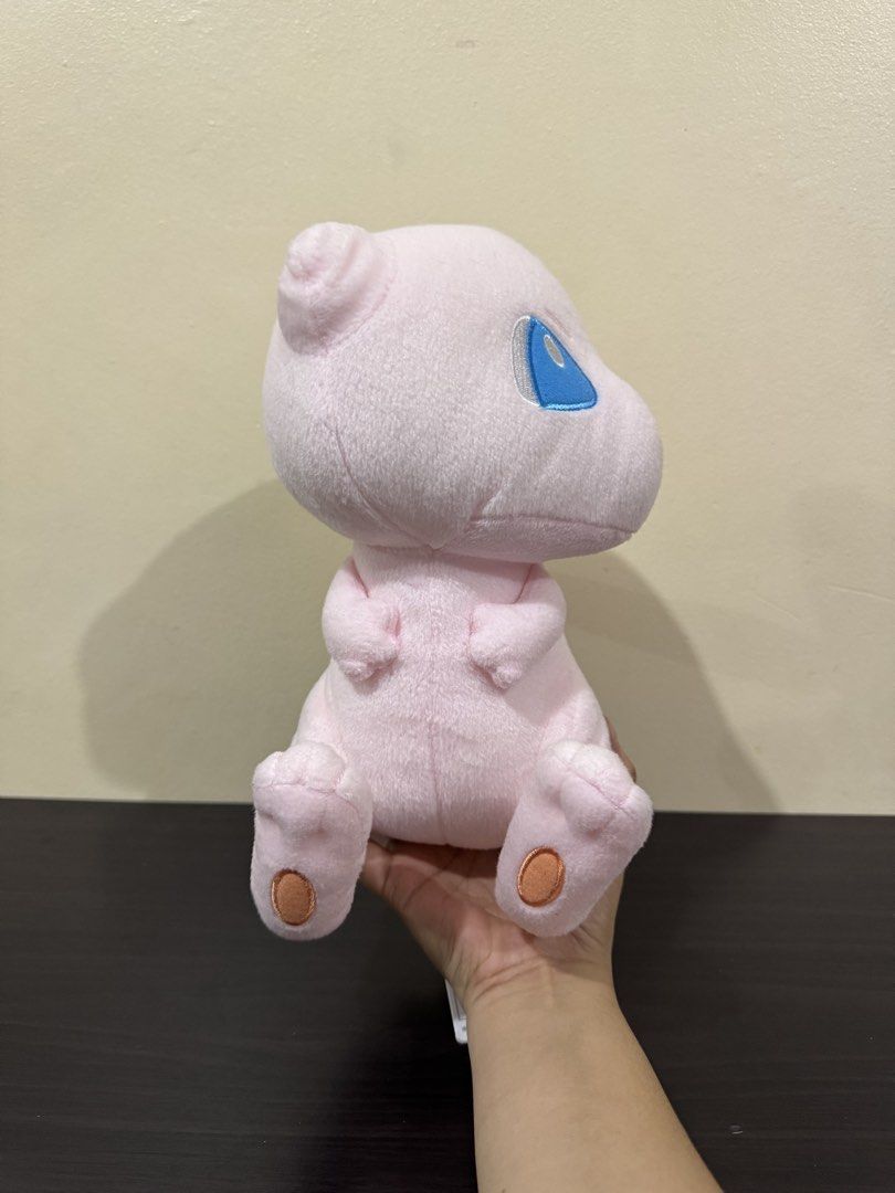 Bandai Spirits Pokémon Mew Plush Toy (Category: Plushies & Soft Toys) located in Cainta. Submitted by mayhroeen (Listing ID 1466966424, Image 1). Description: - Official Banesto prize item by Bandai Spirits (Made in Vietnam) - Features soft pink fabric, cute embroidered blue eyes, and stitched paws - Includes attached paper hang tag and purple tush tag - Built-in white loop string at the top for easy hanging - Condition: Clean and well-maintained