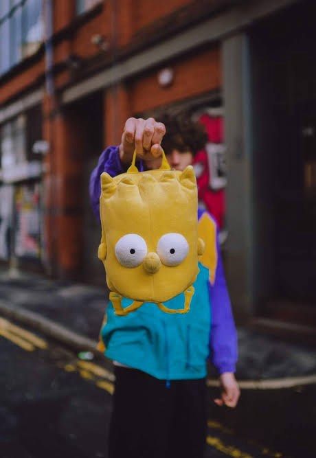 Bart Simpson plush backpack yellow cartoon bag (Category: Babies & Kids Fashion) located in Los Banos. Submitted by italiangoodies (Listing ID 1466943562, Image 2). Description: - Eye-catching bright yellow Bart Simpson plush backpack - Made from super soft and fuzzy material - Features iconic spiky hair and big white eyes on the front - Adjustable yellow straps with buckle closure for a comfortable fit - Top zipper opening with some minor staini