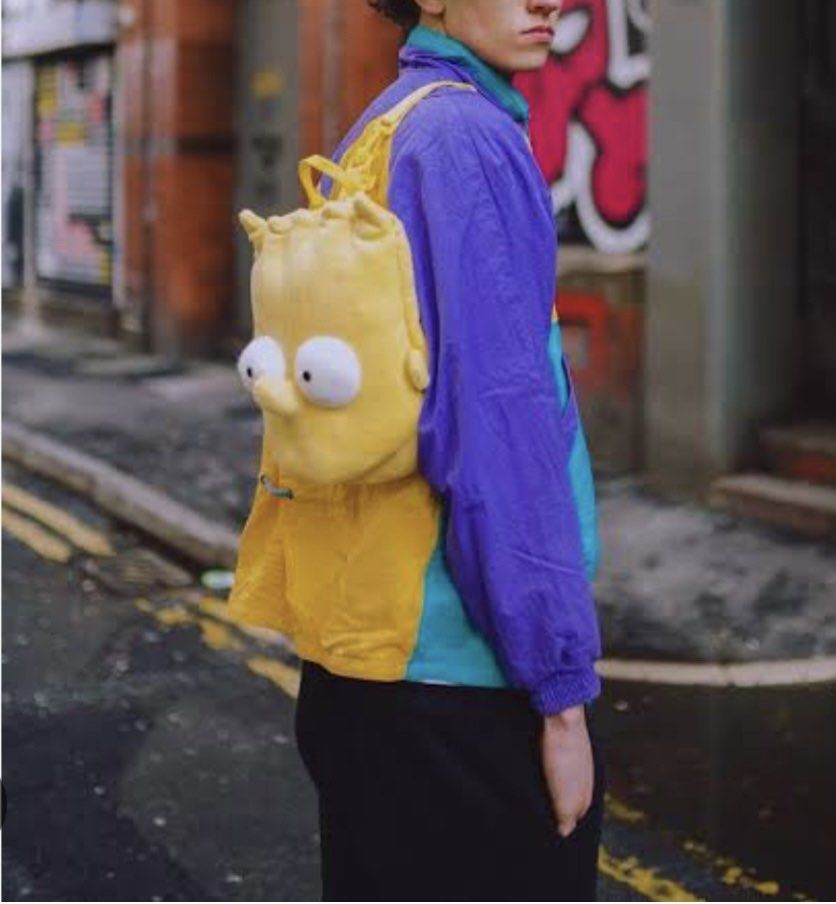 Bart Simpson plush backpack yellow cartoon bag (Category: Babies & Kids Fashion) located in Los Banos. Submitted by italiangoodies (Listing ID 1466943562, Image 1). Description: - Eye-catching bright yellow Bart Simpson plush backpack - Made from super soft and fuzzy material - Features iconic spiky hair and big white eyes on the front - Adjustable yellow straps with buckle closure for a comfortable fit - Top zipper opening with some minor staini