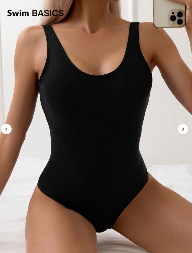 Basic Black One-Piece Swimsuit (Category: Bikinis & Swimsuits) located in Consolacion. Submitted by thisislorraine (Listing ID 1466794267, Image 1). Description: - Color: Solid black - Design: Classic scoop neck with supportive wide shoulder straps - Cut: Flattering high-cut leg style - Fabric: Smooth material with minimal stretch - Versatility: Essential basic piece, perfect for the beach or pool.
