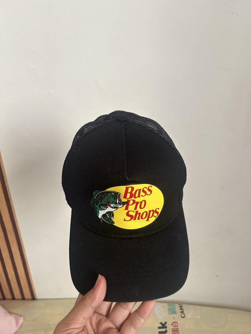 Bass Pro Cap Original (Category: Caps & Hats) located in Taguig. Submitted by iamrhooox (Listing ID 1466782754, Image 3). Description: - Brand: Bass Pro Shops - Color: Black - Style: Trucker hat (Style 638BP-032) - Features iconic fish logo patch on the front - Breathable polyester mesh back panels - Durable cotton front panels - Curved brim for sun protection - Adjustable snapback closure for a custom fit - Perfect for outdoor activities and eve