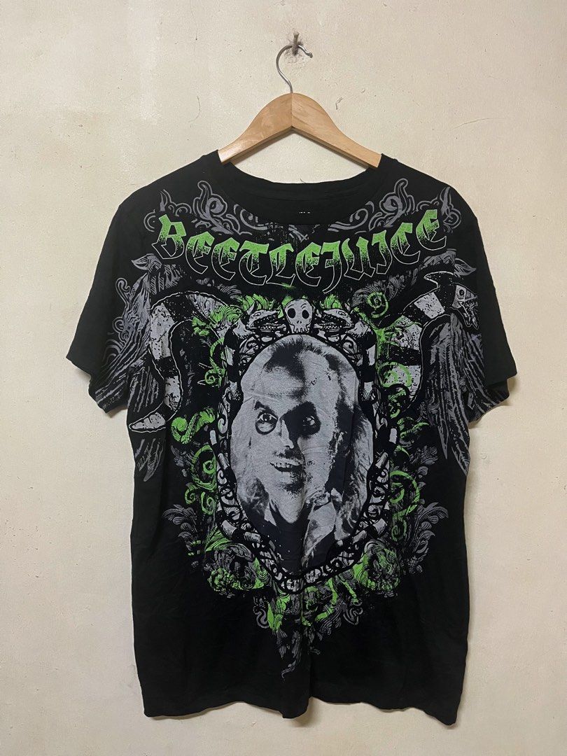 Beetlejuice Graphic Tee Black Green (Category: Tshirts & Polo Shirts ) located in Manila. Submitted by jowellanam76428 (Listing ID 1466917906, Image 1). Description: - Design: Beetlejuice face with ornate details in a striking green and grey print - Style: Heavy metal / movie merchandise aesthetic - Fit: Standard fit, short sleeves, crew neck - Color: Black - Condition: Great piece for fans and collectors—grab it before it's gone!.
