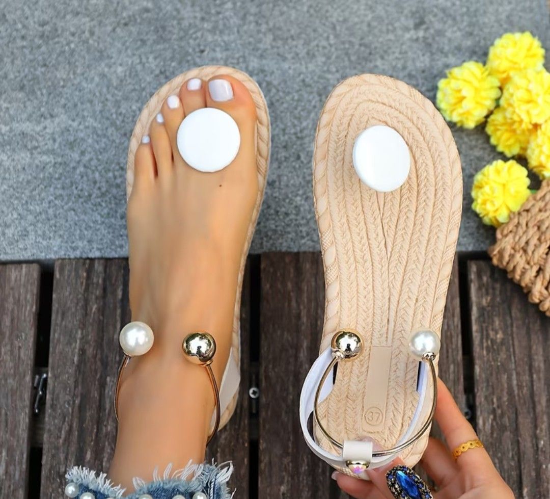 Beige flat sandals with pearl ankle chain size 37 (Category: Flats & Sandals) located in Mandaluyong City. Submitted by zheida1068 (Listing ID 1466777584, Image 1). Description: Chic beige flat sandals in size 37 featuring a woven sole, white toe accent, and a gold-tone ankle strap with pearls and metal beads. Comfortable slip-on style with an elastic back strap. Perfect for casual days or beach trips. Grab these now before they're gone!.