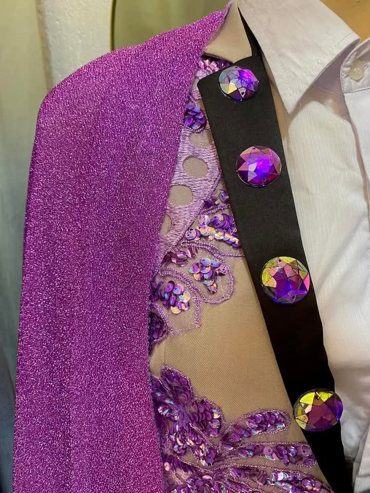Beige suit with purple sequins and cape (Category: Coats, Jackets and Outerwear) located in Dasmarinas. Submitted by sagalagown66473 (Listing ID 1466797493, Image 3). Description: - Style: Custom performance wear, stage outfit, or costume - Color/Design: Beige suit with vibrant purple sequin appliqués, floral embroidery, and black-lined lapels - Details: Large iridescent rhinestone buttons - Included Items: Matching trousers, white collared shirt