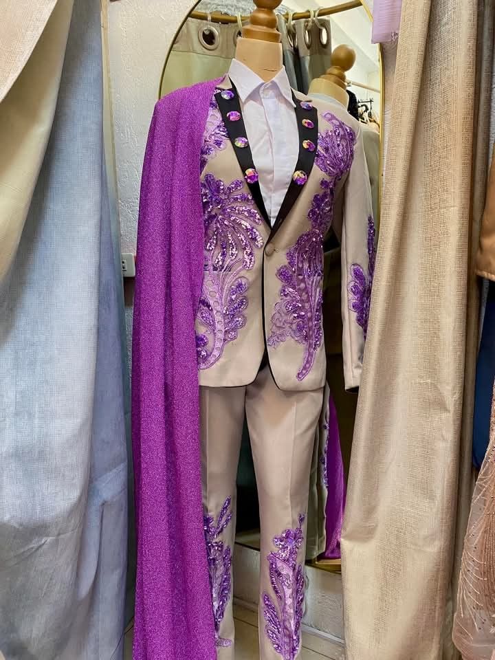 Beige suit with purple sequins and cape (Category: Coats, Jackets and Outerwear) located in Dasmarinas. Submitted by sagalagown66473 (Listing ID 1466797493, Image 1). Description: - Style: Custom performance wear, stage outfit, or costume - Color/Design: Beige suit with vibrant purple sequin appliqués, floral embroidery, and black-lined lapels - Details: Large iridescent rhinestone buttons - Included Items: Matching trousers, white collared shirt