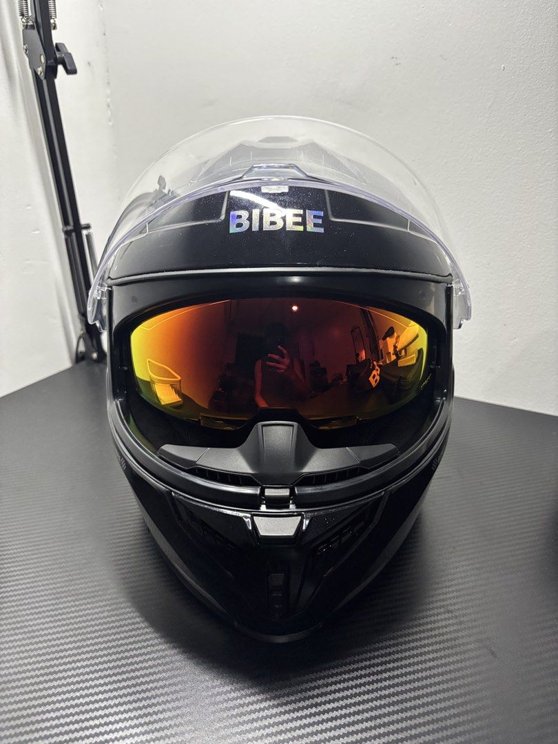 BIBEE Black Glitter Motorcycle Helmet with Dual Visors DOT ECE (Category: Helmets and other Riding Gears) located in Manila. Submitted by jezzierain17683 (Listing ID 1466941129, Image 2). Description: BIBEE PHANTOM FULL-FACE HELMET ✔️ Brand: BIBEE ✔️ Model: Phantom ✔️ Full-face helmet ✔️ Glossy Black ✔️ Gold/Orange mirror visor ✔️ Clear outer visor ✔️ Dual visors ✔️ Sporty aerodynamic design ✔️ Comfortable padded interior ✔️ Front ventilation ✔️ 