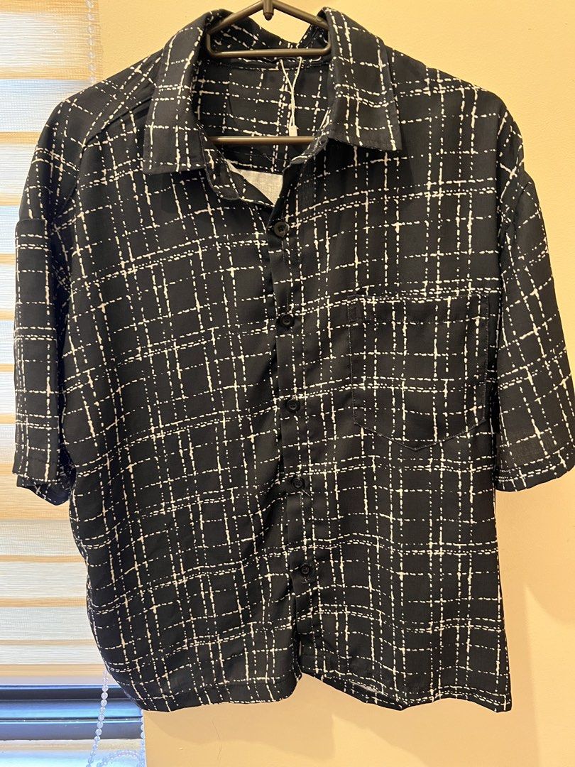 Black and White Grid Pattern Short Sleeve Shirt (Category: Shirts) located in Las Pinas. Submitted by basicapparel_mnl (Listing ID 1466968578, Image 3). Description: - Style: Camp collar short sleeve button-down - Design: Black with white dashed grid print - Details: Single left chest pocket, front button closure - Fit: Relaxed and lightweight - Condition: Brand new with tag attached.