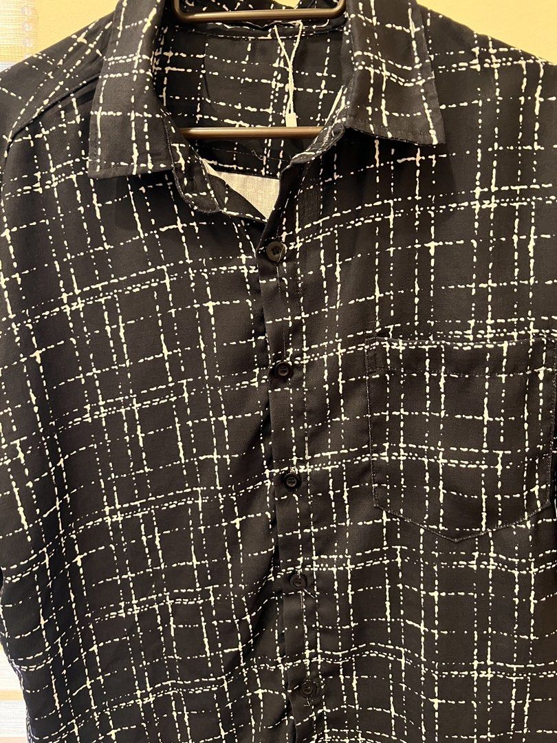 Black and White Grid Pattern Short Sleeve Shirt (Category: Shirts) located in Las Pinas. Submitted by basicapparel_mnl (Listing ID 1466968578, Image 2). Description: - Style: Camp collar short sleeve button-down - Design: Black with white dashed grid print - Details: Single left chest pocket, front button closure - Fit: Relaxed and lightweight - Condition: Brand new with tag attached.