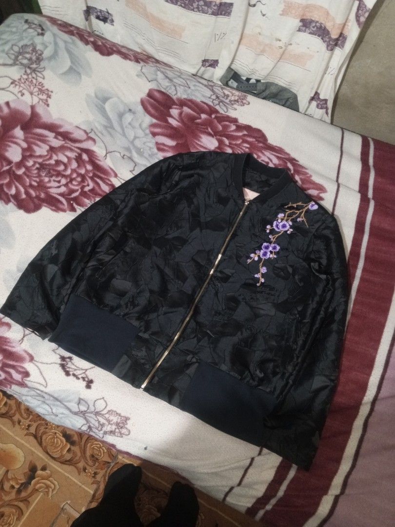 Black bomber jacket with floral embroidery (Category: Coats, Jackets and Outerwear) located in Baguio. Submitted by tyrontoler83676 (Listing ID 1466933957, Image 1). Description: - Color: Classic black - Design: Textured geometric pattern all over - Details: Eye-catching purple cherry blossom embroidery on the left chest - Hardware: Premium gold-tone front zip-up closure - Fit/Trim: Comfortable ribbed black cuffs and hem - Condition: Clean overal