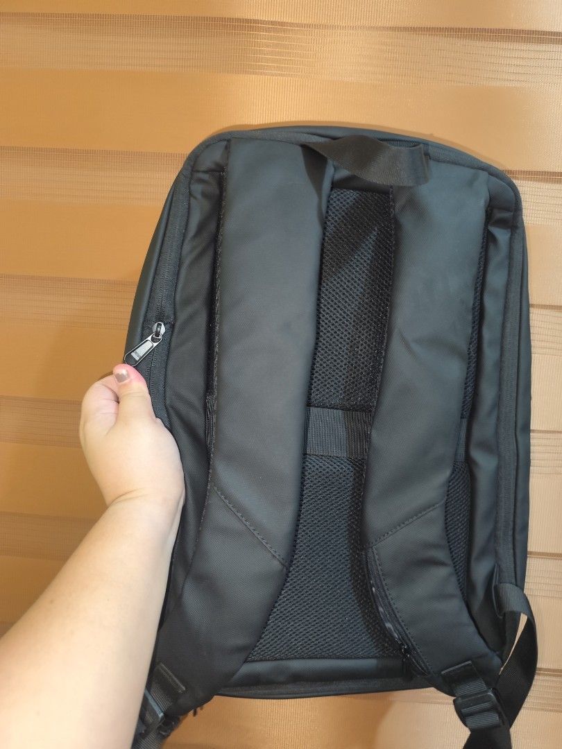 Black geometric hard-shell laptop backpack with multiple compartments (Category: Backpacks) located in Naga. Submitted by semflewer (Listing ID 1466832828, Image 2). Description: - Sleek black minimalist design with a structured geometric front panel - Comfortable daily wear with padded mesh back straps and back panel - Secure hidden zippered pocket on the back for valuables - Deep main compartment with practical side pockets - Reinforced top han