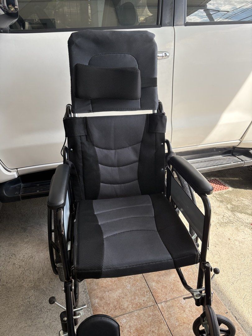 Black High-Back Reclining Wheelchair with Headrest (Category: Wheelchairs) located in Paranaque City. Submitted by maisabelpineda (Listing ID 1466859662, Image 2). Description: - Color: Black heavy-duty design - Comfort: High back with adjustable headrest and breathable mesh padding - Support: Padded armrests and footrests - Mobility & Safety: Large rear wheels with hand rims and parking brakes - Frame & Portability: Solid metal frame, clean cond