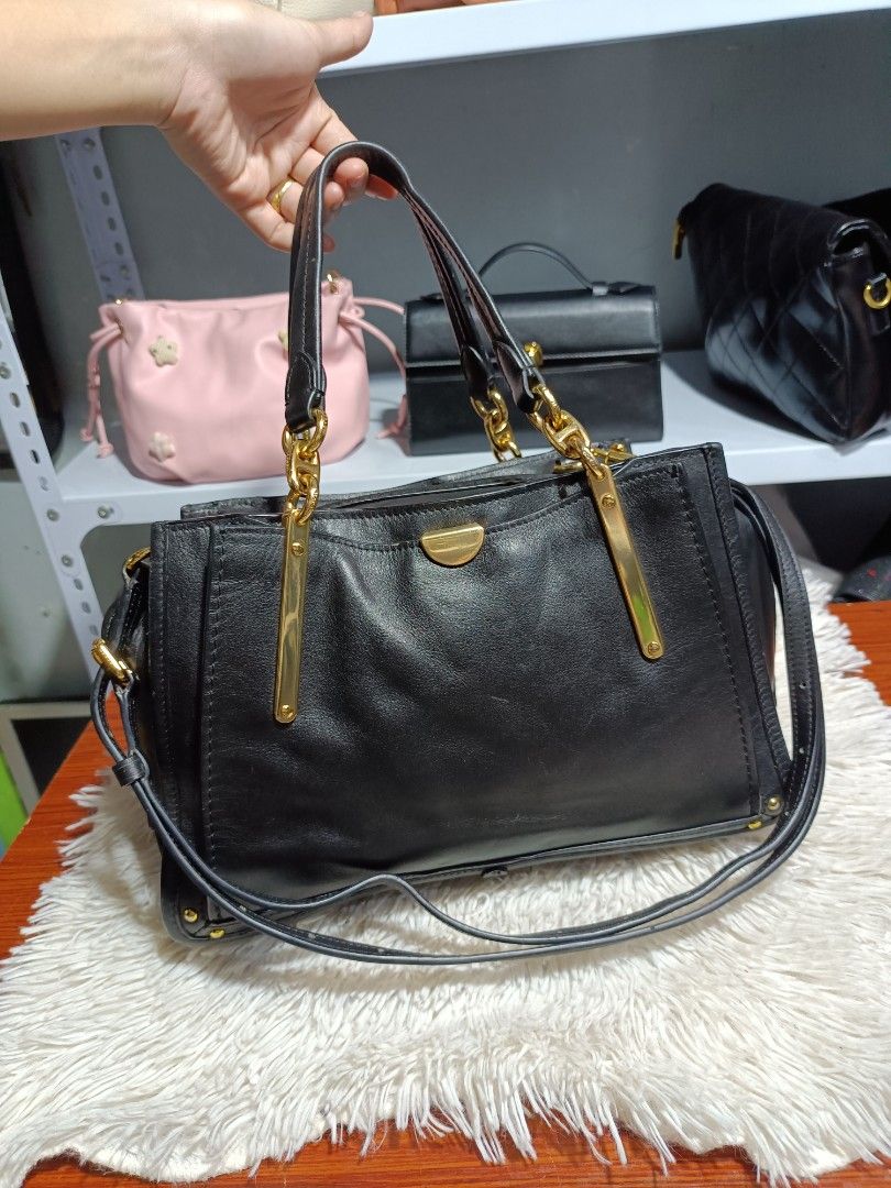 Black Leather Handbag with Gold Hardware (Category: Luxury Bags & Wallets) located in Naga. Submitted by zksboutique (Listing ID 1466779465, Image 2). Description: - Color & Material: Classic black leather with shiny gold hardware - Design: Structured shape with sleek metal bars on the front - Carry Options: Double top handles and a long adjustable shoulder strap - Closure: Secure top zipper closure - Interior: Multiple compartments for easy orga