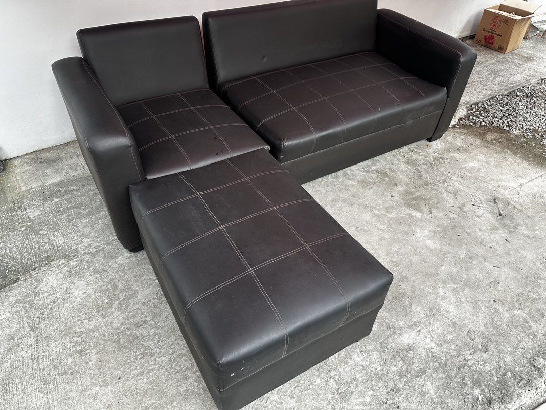 Black leather sectional sofa with matching ottoman (Category: Sofas) located in Pateros City. Submitted by cmlr.items (Listing ID 1466954402, Image 3). Description: - Dark brown faux leather sectional sofa setup - Includes a 2-seater section, corner chair, and movable ottoman - Stylish grid-stitched detailing on seat cushions - Modern design with thick, sturdy armrests on both ends - Ideal for living rooms or office spaces Original price 14k .