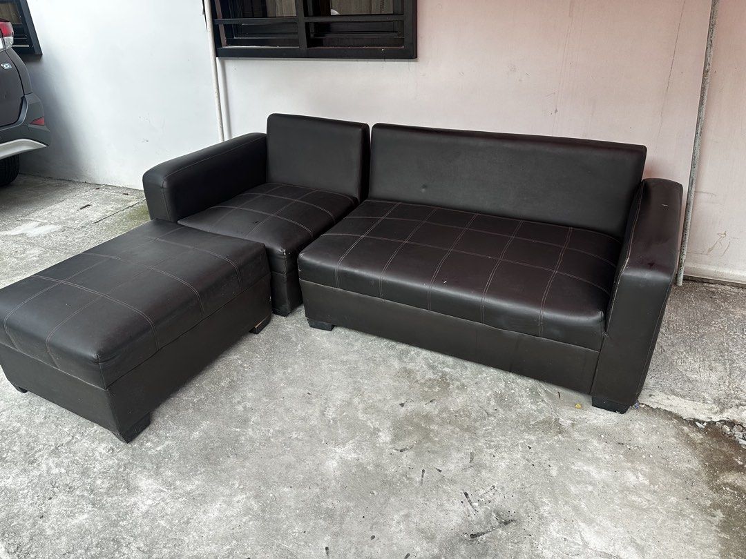 Black leather sectional sofa with matching ottoman (Category: Sofas) located in Pateros City. Submitted by cmlr.items (Listing ID 1466954402, Image 1). Description: - Dark brown faux leather sectional sofa setup - Includes a 2-seater section, corner chair, and movable ottoman - Stylish grid-stitched detailing on seat cushions - Modern design with thick, sturdy armrests on both ends - Ideal for living rooms or office spaces Original price 14k .