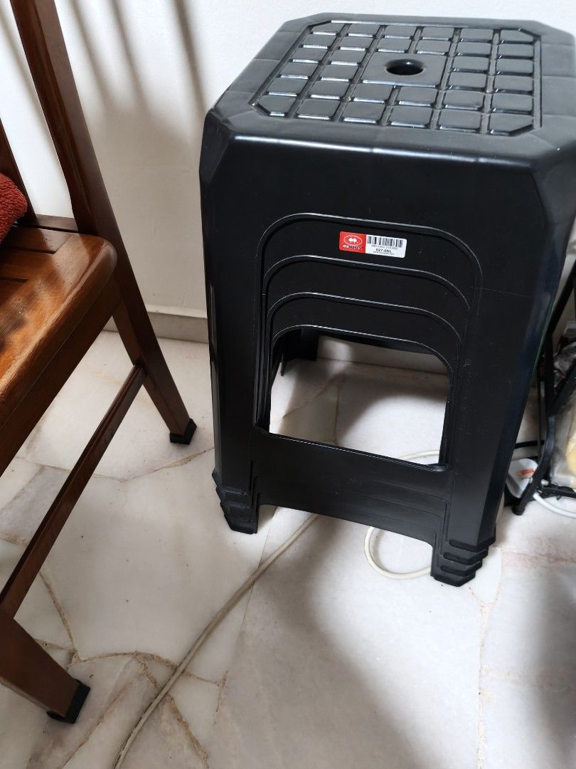 Black plastic stackable stool (Category: Chairs) located in Singapore. Submitted by wendi.liuaina (Listing ID 1466934009, Image 1). Description: - Color: Black - Material: Durable plastic - Design: Textured square seat with center hole for easy lifting - Space-saving: Stackable for compact storage - Condition: Clean overall - Versatility: Ideal everyday seating for home or office.