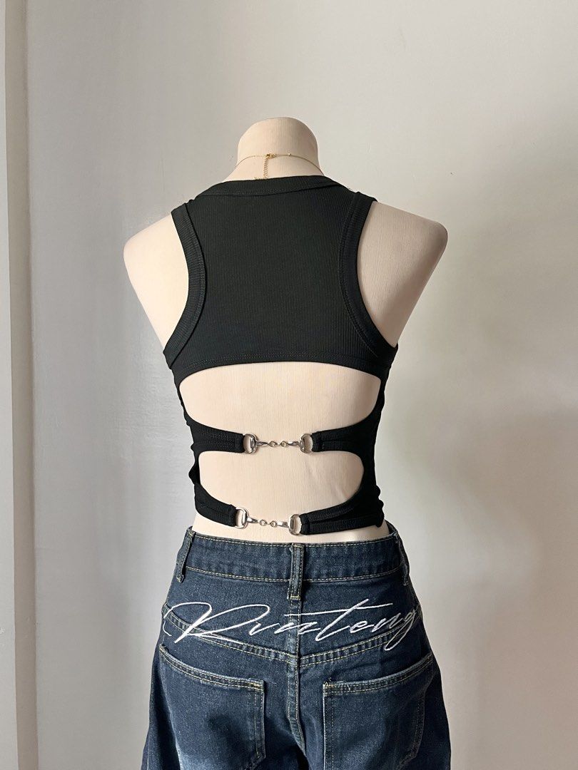 Black Ribbed Open Back Tank Top with Silver Hardware (Category: Sleeveless) located in Pasig City. Submitted by lovebella.apparel (Listing ID 1466950615, Image 2). Description: backless top 𐙚 – ₱50 – xs to semi l – padded – stretchable – never been used – og price: ₱149 📍pasig/antipolo DM or comment "mine" to order. (𝘛𝘩𝘦 𝘤𝘰𝘭𝘰𝘳 𝘮𝘢𝘺 𝘷𝘢𝘳𝘺 𝘥𝘶𝘦 𝘵𝘰 𝘭𝘪𝘨𝘩𝘵𝘪𝘯𝘨).
