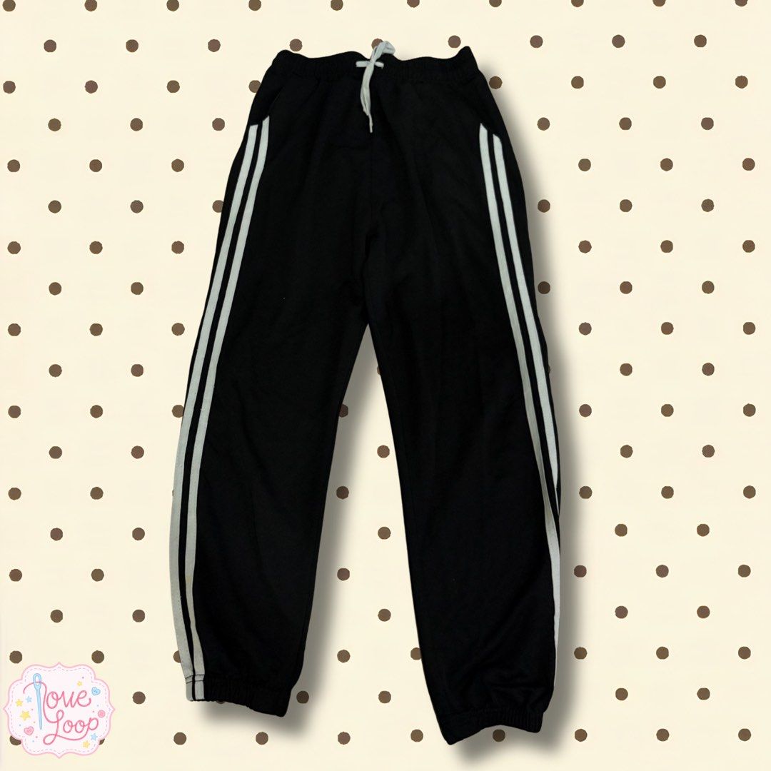 Black Track Pants with White Side Stripes and Drawstring Waist (Category: Joggers) located in Manila. Submitted by love.loop (Listing ID 1466889903, Image 1). Description: - Color: Classic black with white side stripes - Fit: Relaxed fit with soft, comfortable material - Waistband: Elastic with a light grey adjustable drawstring - Ankles: Cuffed for a snug feel - Pockets: Two functional side pockets - Best for: Lounging, workouts, or running dail