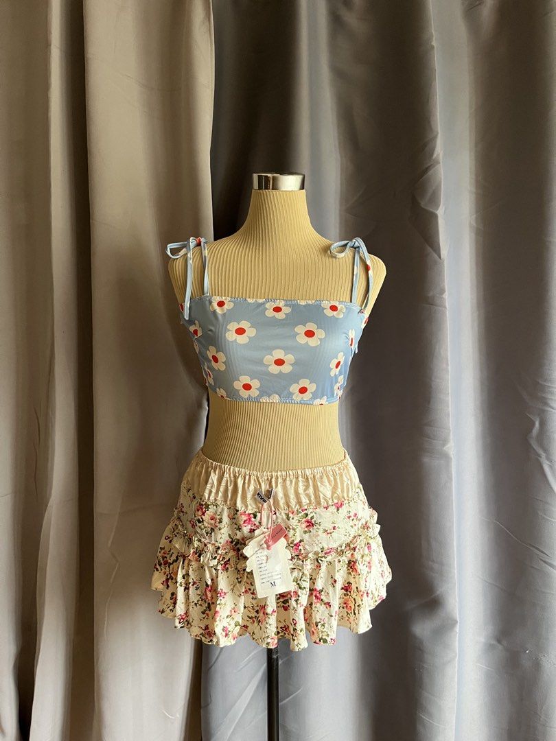 Blue Daisy Tie-Strap Crop Top (Category: Sleeveless) located in Cagayan de Oro. Submitted by curated_closetph (Listing ID 1466895979, Image 1). Description: — Sweetheart-vibe straight neckline adorned with large, bold white daisy prints featuring vibrant red centers — Designed with playful and adjustable tie-strap shoulders for a customizable and perfect fit — Soft and stretchy light blue ribbed fabric that hugs your shape comfortably — When to w