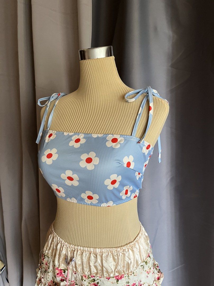 Blue Daisy Tie-Strap Crop Top (Category: Sleeveless) located in Cagayan de Oro. Submitted by curated_closetph (Listing ID 1466895979, Image 2). Description: — Sweetheart-vibe straight neckline adorned with large, bold white daisy prints featuring vibrant red centers — Designed with playful and adjustable tie-strap shoulders for a customizable and perfect fit — Soft and stretchy light blue ribbed fabric that hugs your shape comfortably — When to w