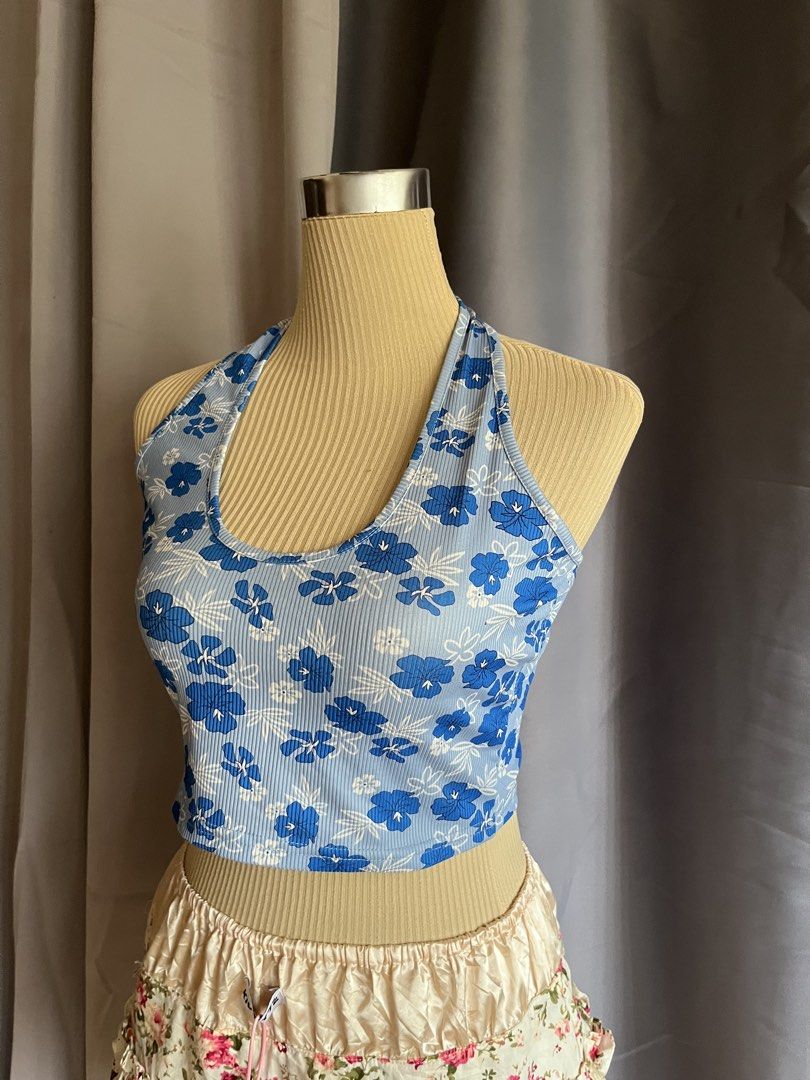Blue Floral Halter Top (Category: Sleeveless) located in Manila. Submitted by curated_closetph (Listing ID 1466886184, Image 2). Description: — Vibrant blue with a tropical hibiscus print over textured ribbed fabric — Features a flattering halter neckline and comfortable cropped fit — When to wear: Perfect for beach days, summer festivals, or casual daytime outings — How to style: Pairs perfectly with high-waisted denim shorts, white linen pants,
