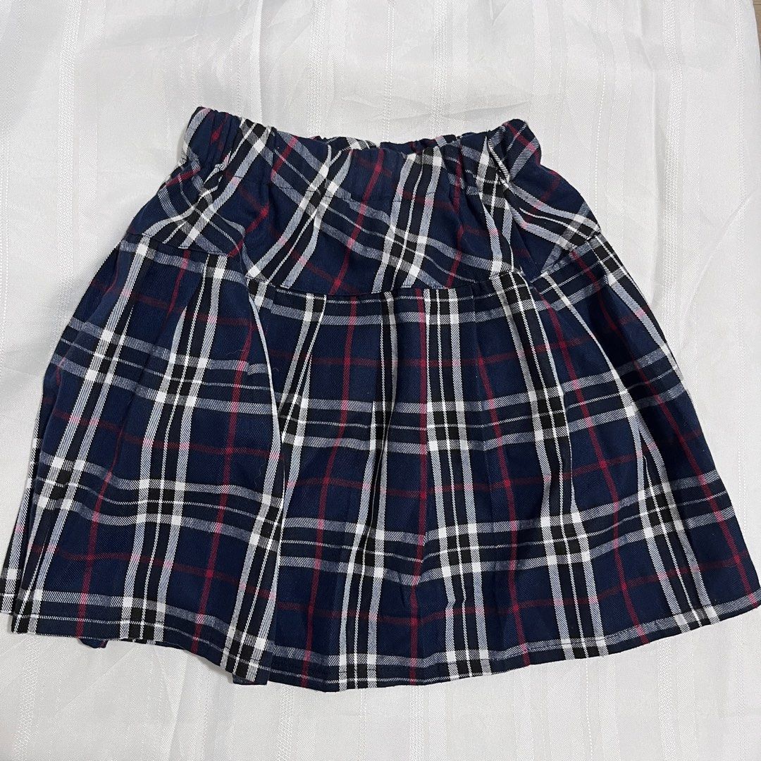 Blue Plaid Pleated Mini Skirt (Category: Skirts) located in Baguio. Submitted by gbwardrobe (Listing ID 1466935659, Image 1). Description: - Color: Navy blue with red, white, and black tartan plaid - Style: Classic pleated skater skirt - Fit: Easy pull-on style with a comfortable elastic waistband - Versatility: Great for casual everyday looks, pairs well with sweaters or tees - Condition: Brand new / Excellent pre-loved.