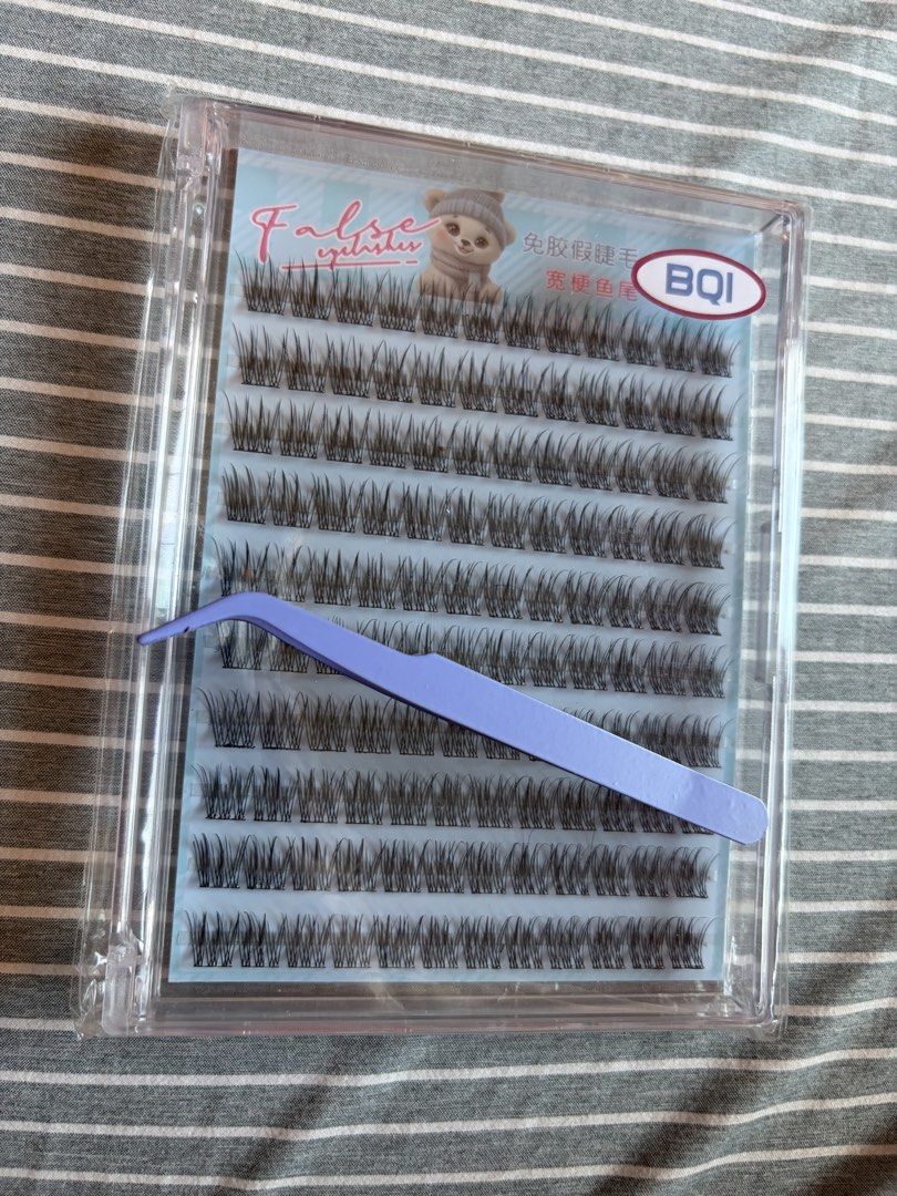 BQI False Eyelashes with Tweezers Clear Case (Category: Makeup) located in Quezon City. Submitted by mmiyah27 (Listing ID 1466791571, Image 1). Description: - Brand: BQI - Condition: Brand new, clean, and sealed in original packaging - Design: Multiple rows of individual-style false eyelashes - Inclusion: Free purple applicator tweezer for easy and precise grabbing - Storage: Comes in a durable clear plastic case for convenient organization.