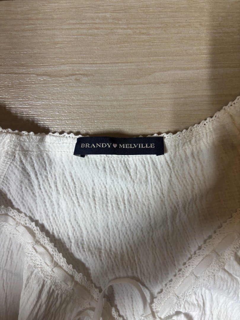 Brandy Melville White lani Top (Category: Blouses) located in Paranaque City. Submitted by preloved_archives (Listing ID 1466839136, Image 3). Description: - Brand: Brandy Melville - Color: White - Style: Crinkled textured short-sleeve top with V-neck and front tie - Bought but Never worn .